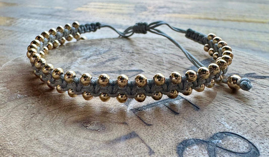 Pulsera gris y dorado